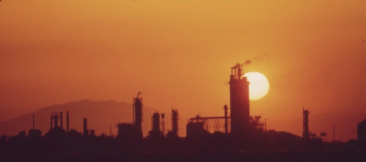 Industrial processing plant silhouetted at sunset